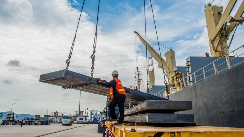 cargo steel slab discharging from the ship vessel laying onto the lorry trailer