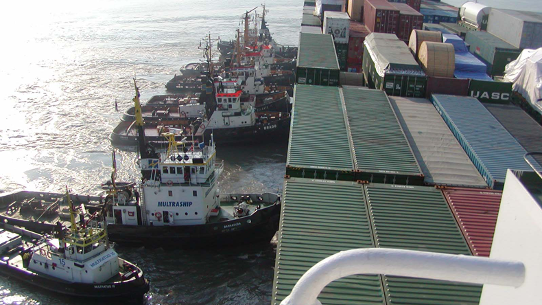 Salvors tugs pushing a grounded vessel