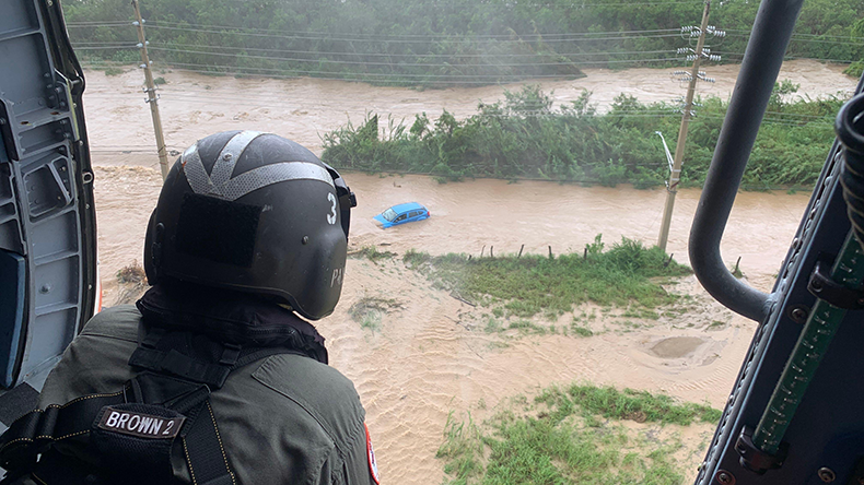 Southern Coast, Puerto Rico. 19th Sep, 2022. A Coast Guard MH-60T Jayhawk helicopter aircrew from Air Station Borinquen checks for signs of a survivor in a flooded vehicle in the southern coast of Puerto Rico during the initial Coast Guard coastal and port assessment flight following Hurricane Fiona. 