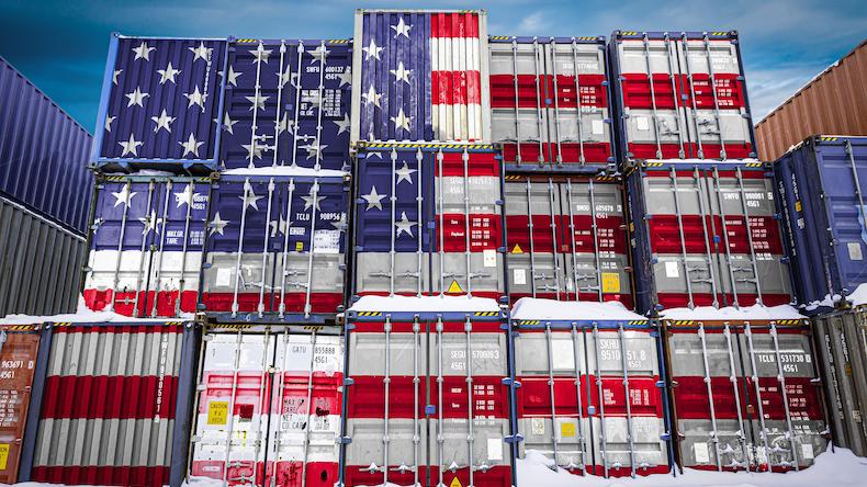 The national flag of USA on a large number of metal containers for storing goods stacked in rows on top of each other. Alamy 2AWT2NA