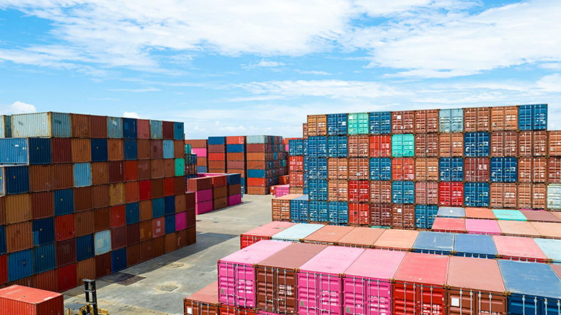 Containers stacked up outside for import and export at a manufacturing factory