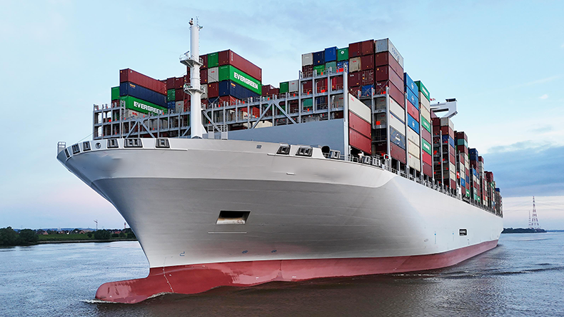 Front view of a mega containership on a river