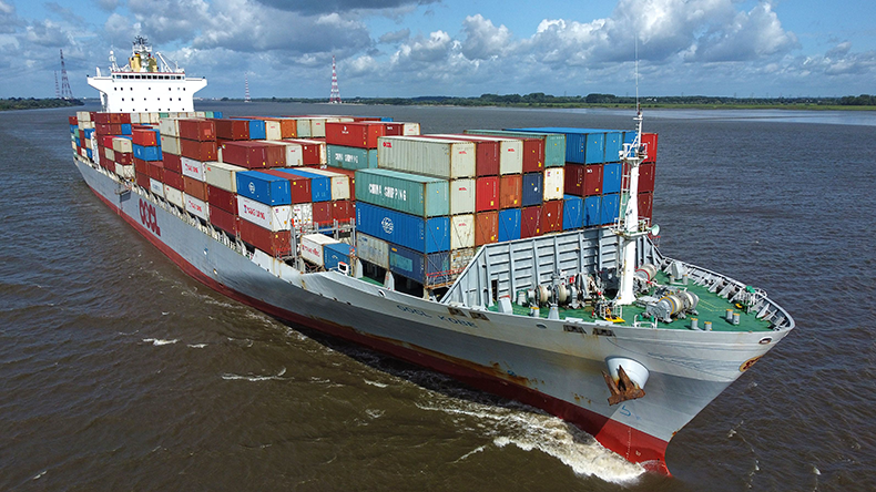 Panamax containership on a river with blue sky and white clouds
