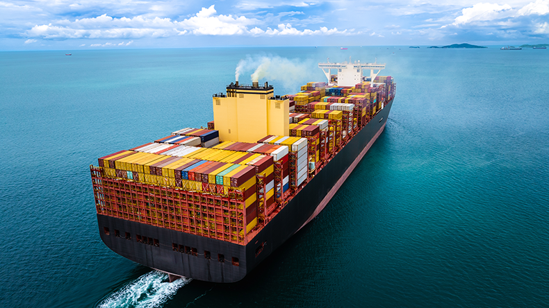 Containership at sea importing and exporting goods with a blue sky and white clouds