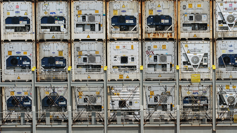 White reefer containers of various shipper stowed and secured on the aft bay of container vessel