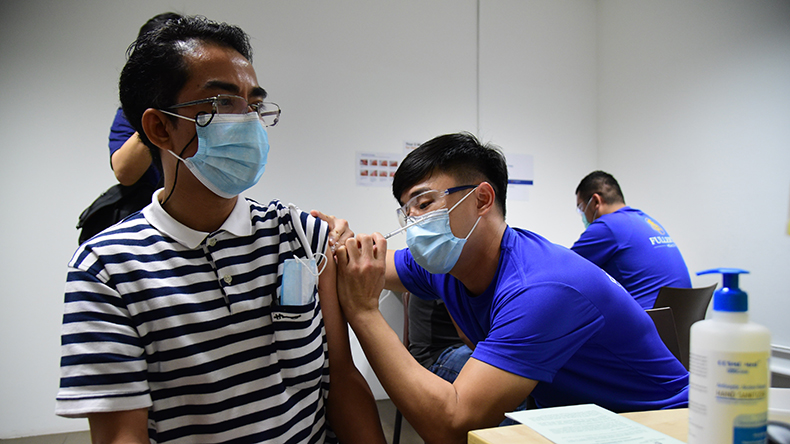 Non-resident foreign sea crew getting a coronavirus vaccination in Singapore