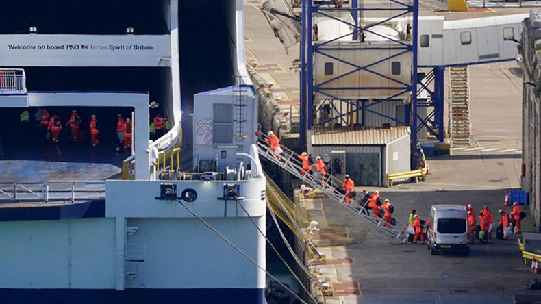 Workers carrying luggage board the P&O Ferry Spirit of Britain at the Port of Dover in Kent