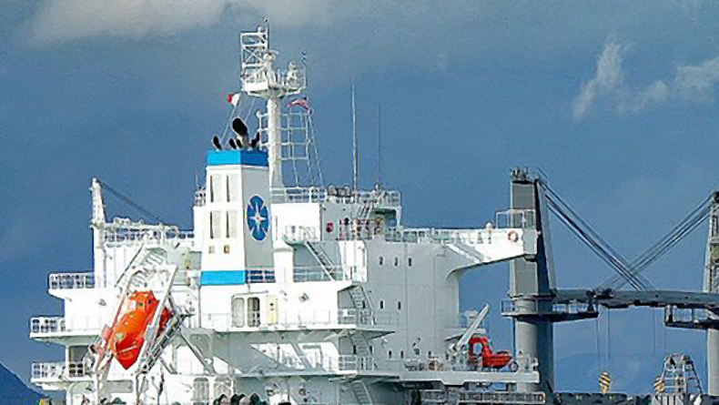 Sea Trade Holdings logo on funnel of bulker