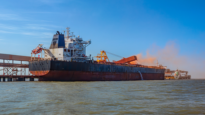 Loading bulk ship with bauxite aluminum ore at Kamsar port, Guinea