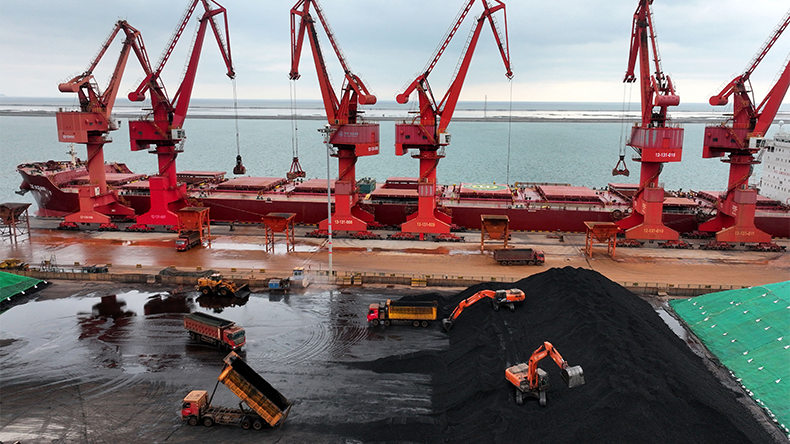 Imported coal is piled up after being unloaded from a ship at the coal terminal at the port in Lianyungang, in China