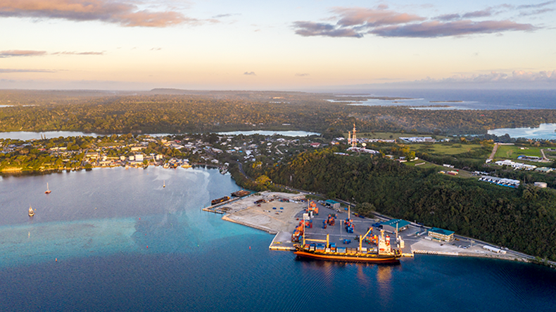 Aerial view of a container ship loading cargo in the commercial dock of Port Vila, Vanuatu, capital city in the south Pacific.