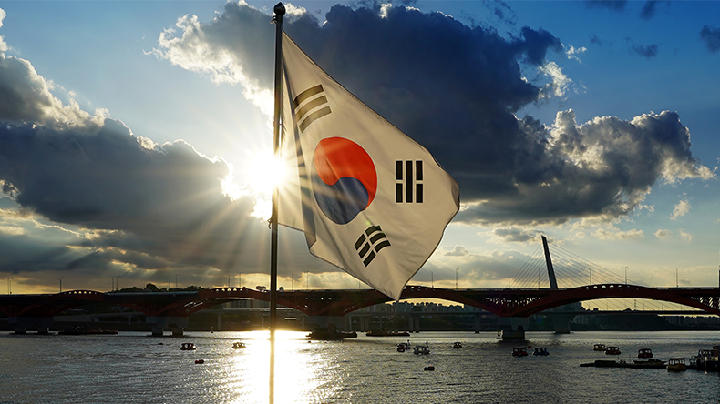 South Korea's flag above the Han river with Seoul's Bridges and Sunset Clouds