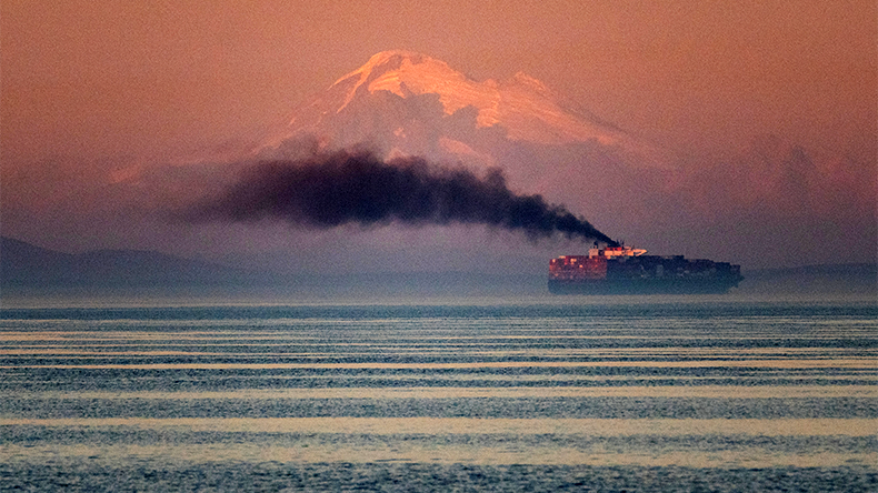 Cargoship in the distance with exhaust fumes and Mt. Baker in the distance