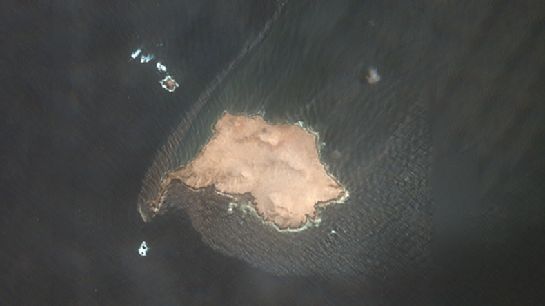 Satellite view of Oman island with oil slick surrounding it at sea