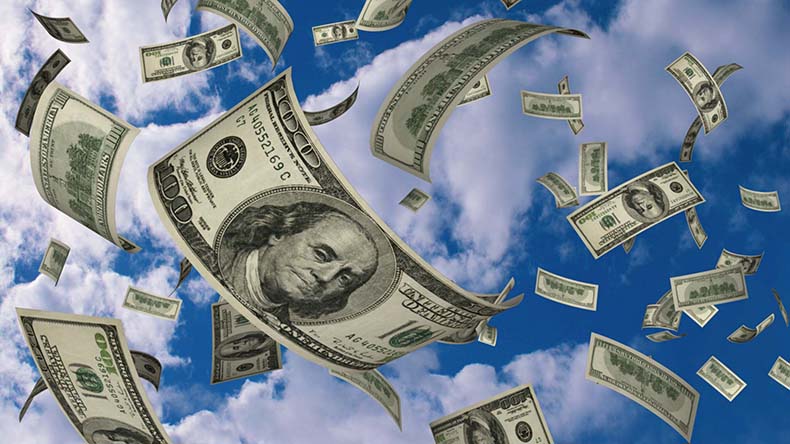 US dollars fly on blue sky background