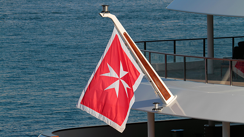 Image of merchant flag of Malta on the stern of a ship.