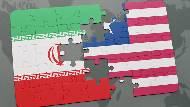 Puzzle with the national flag of iran and Liberia on a world map background