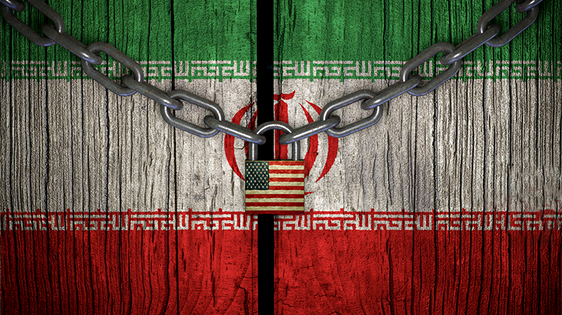 Flag of Iran painted on old and cracked wooden door, which is closed by an old chain and a padlock. Concept of the economic sanctions