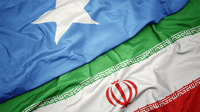 Waving colourful flag of Iran and national flag of Somalia