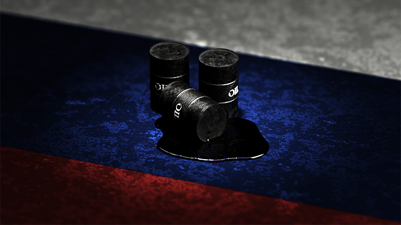 Oil drums and a reflective puddle placed on a textured surface, bathed in the red, blue, and white hues of the Russian flag