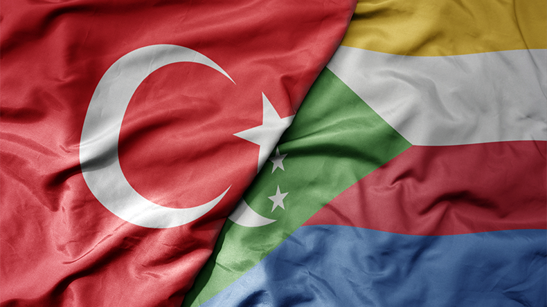 Big waving national colourful flag of Turkey and national flag of Comoros