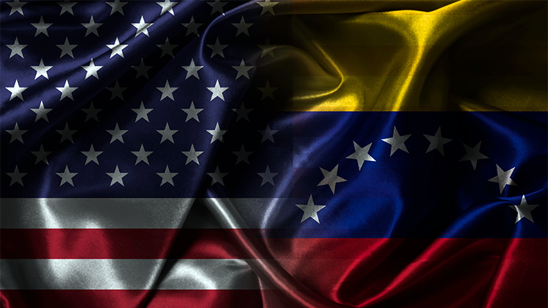 Split waving fabric flags representing USA versus Venezuela