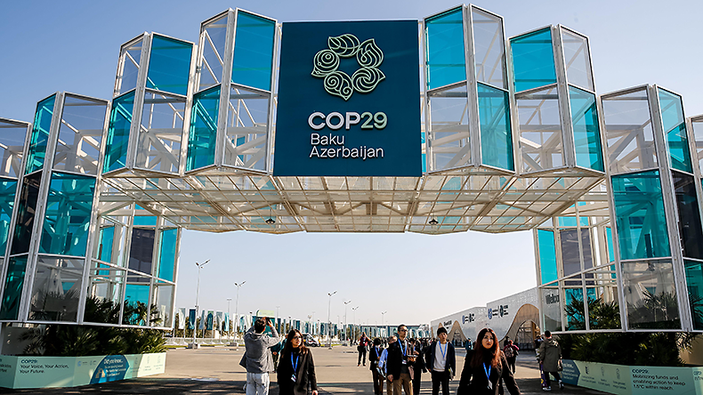 COP29 Participants walk in front of COP29 entrance as UN Climate Change Conference starts in Baku, Azerbaijan