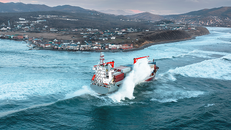 Containership in rough sea near land