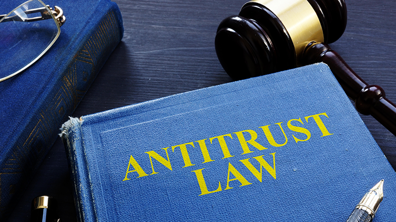  Antitrust law book and gavel on a desk. 