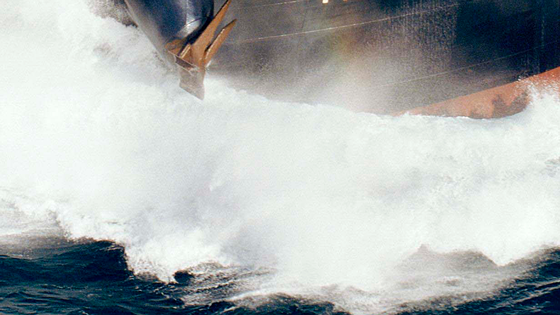 The bow of a tanker cutting through the sea