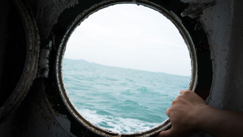 Sea glimpsed through ship porthole