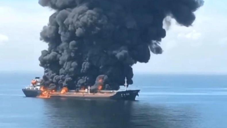 Chemical tanker on fire with black smoke at sea