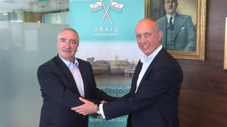 Alasdair Evitt, Group Director, Ship Management East, V.Group shakes hands with Hugh Williams, Chief Executive Officer, Graig Shipping Plc
