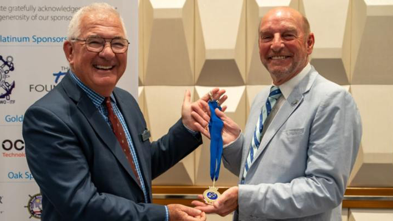 Captain André LeGoubin (L) passes The Nautical Institute’s Presidential Medallion to Captain Trevor Bailey.