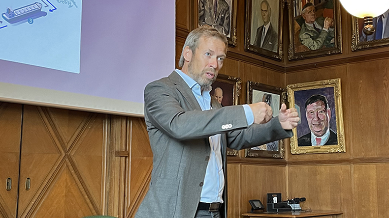 Torvald Klaveness chief Ernst Meyer speaking  animatedly at a conference