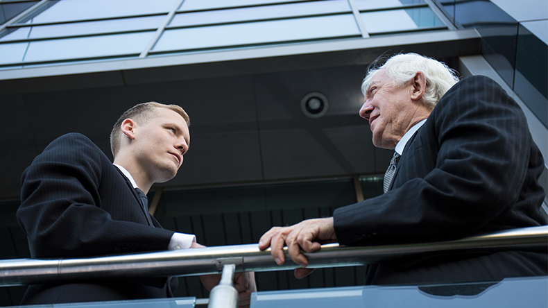 Two men conversing outside