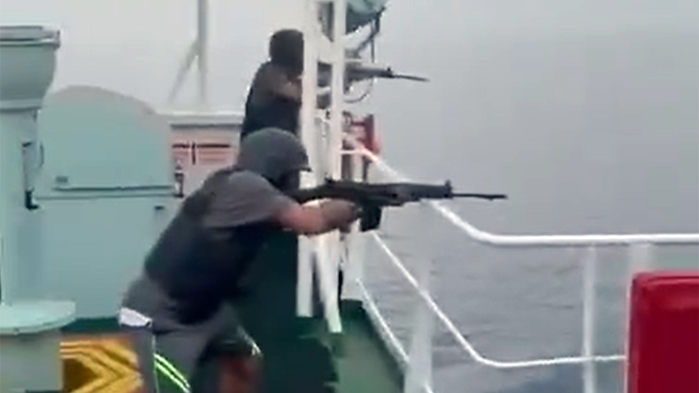 Armed guards on a containership firing machine guns