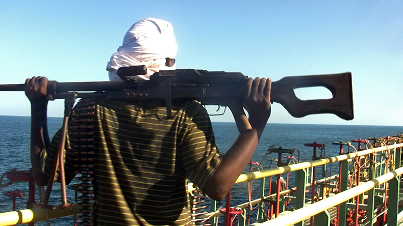 Somali pirate with machine gun on a tanker