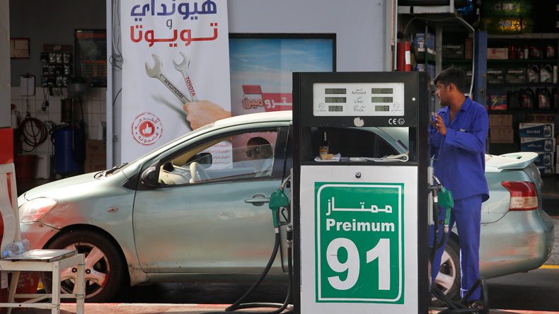 A worker refuels a car at a gas station in Jiddah, Saudi Arabia, Monday