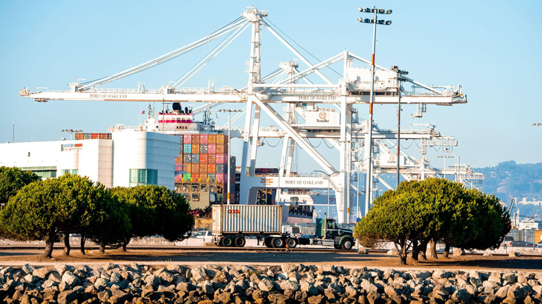 Truck carrying container at port of Oakland, California