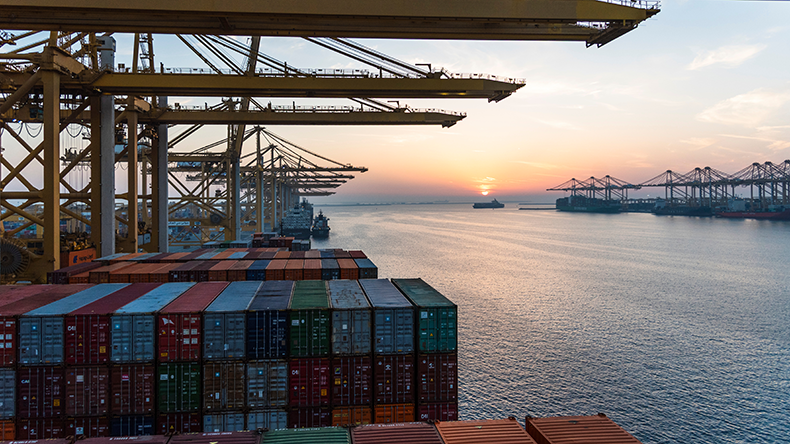 Beautiful sunset silhouette of ships and gantry cranes in the port of Jebel Ali