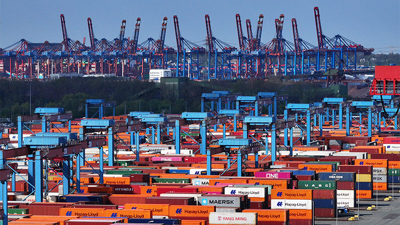Aerial view shipping containers lie stacked in Hamburg port on April 15, 2025 in Germany