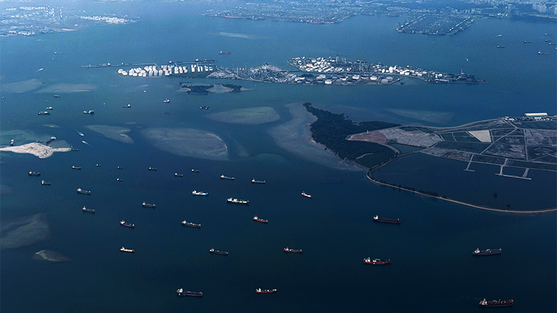 Ships sail along the Singapore Strait, as seen from a plane, on April 19, 2026 