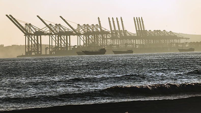 Salalah port with cranes and ships at sunset, Oman