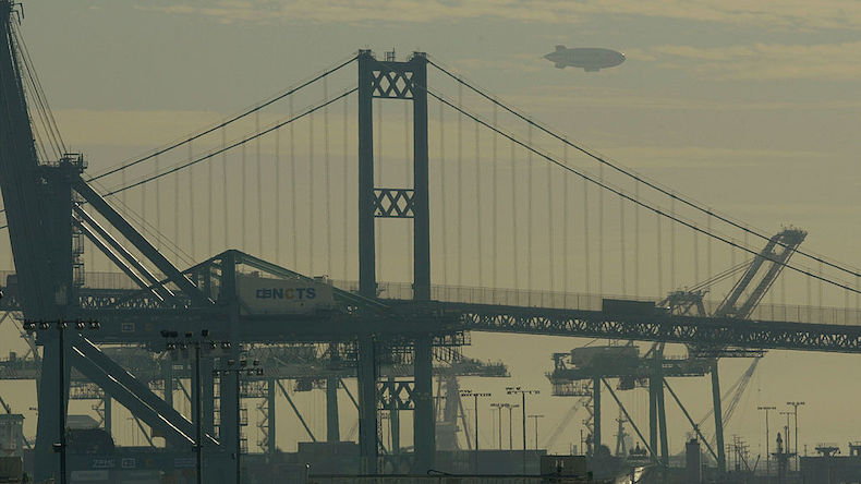LOS ANGELES - DECEMBER 18:  Smog envelopes the Vincent Thomas Bridge, a blimp and shipping yard cranes in the shipyards of the Port of Long Beach December 18, 2003 in Los Angeles, California. Weather conditions have created clear skies for southern California which, in turn, have concentrated smog over the Ports of Los Angeles and Long Beach.  (Photo by David McNew/Getty Images)