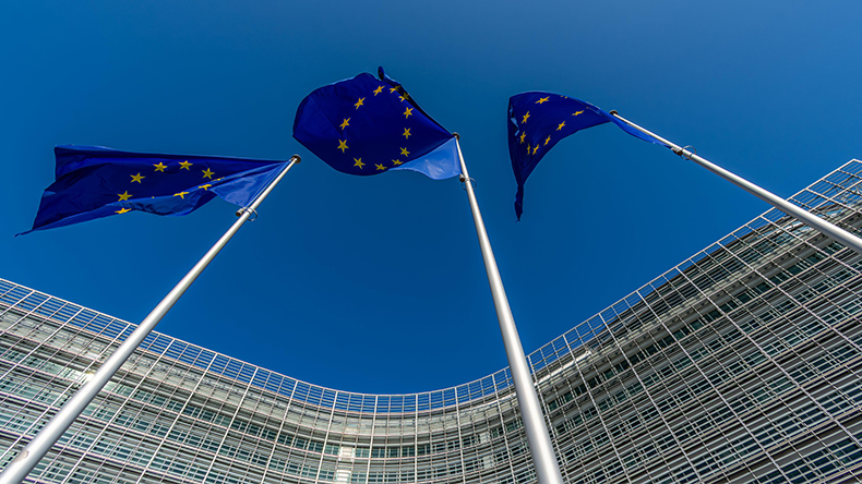 European Union flags and the headquarters of the European Commission