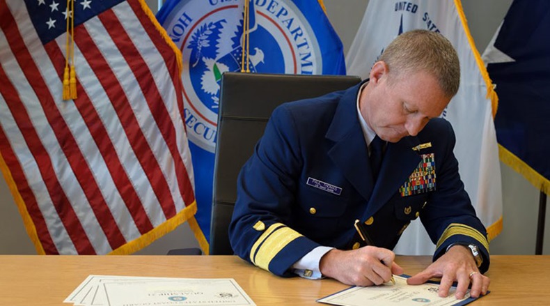 Rear Adm. Thomas signs the first round of E-zero certificates for qualifying ships under the QUALSHIP 21 initiative.