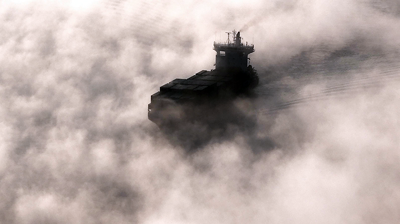 Containership travelling through the mist