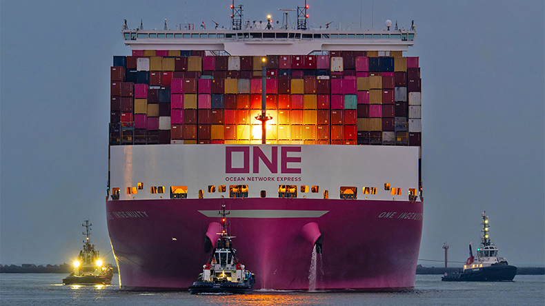 Containership arriving at port at night