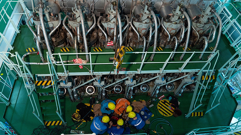 Crew maintain the main engine of Jinhaifa vessel at the Nanjiang port, north China